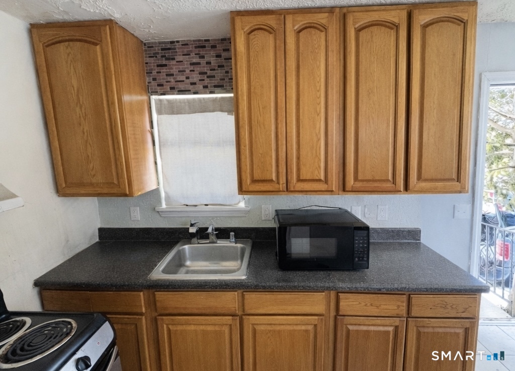 44 Abcd Angel Drive Waterbury, CT 06708 - Photo 2 of 20 a kitchen with granite countertop cabinets and window