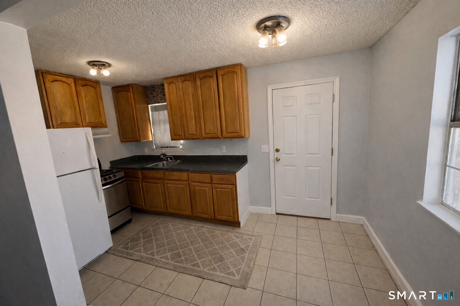 44 Abcd Angel Drive Waterbury, CT 06708 - Photo 4 of 20 a kitchen with a refrigerator and a stove top oven