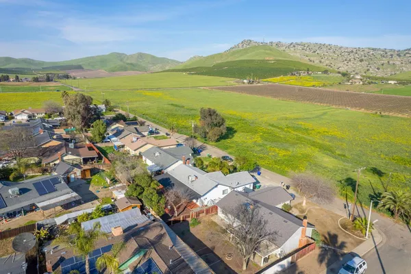a aerial view of a house with a yard and potted plants
