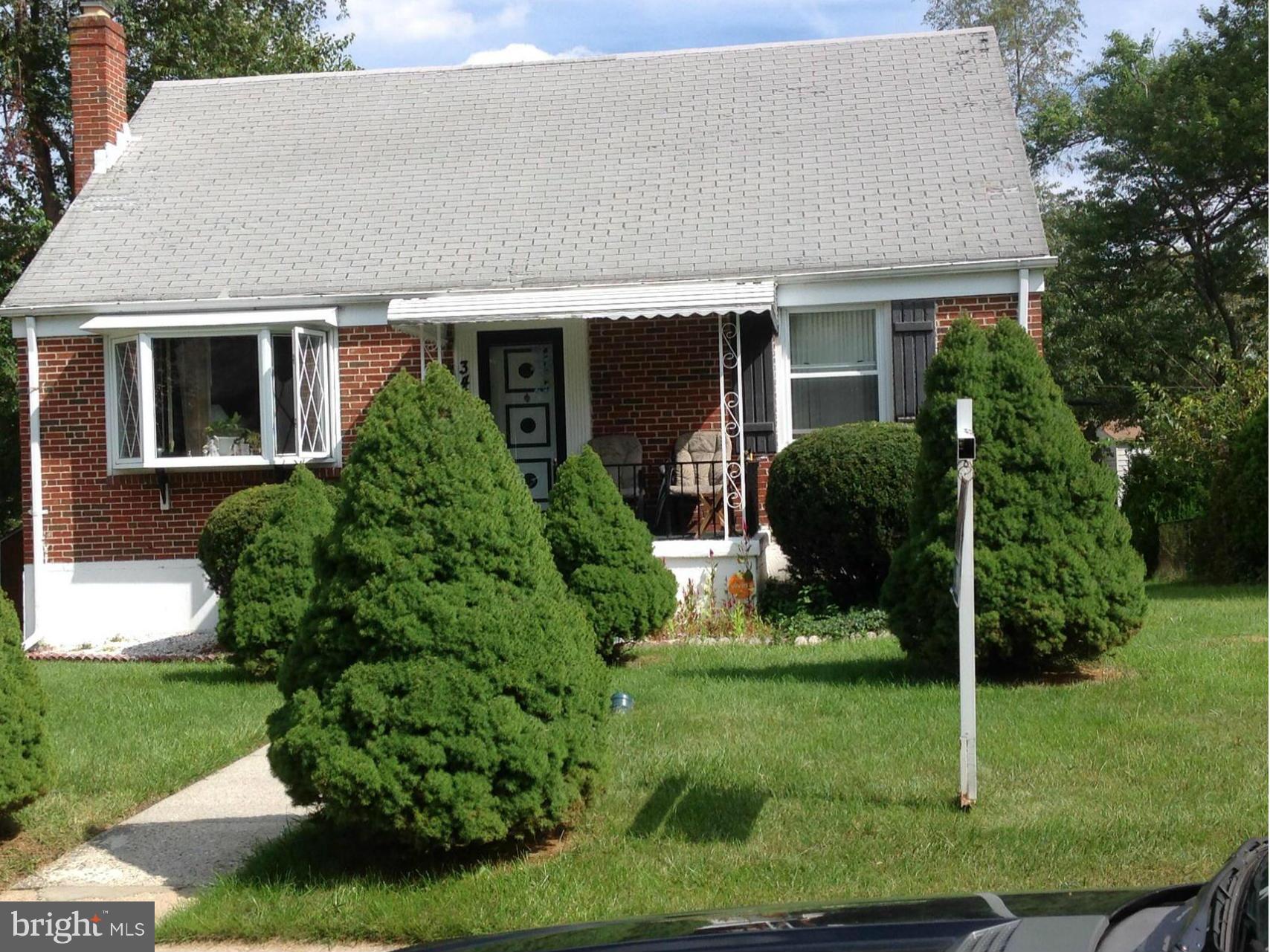 3409 Fairview Road Baltimore, MD 21207 - Photo 1 of 3 a front view of house with a yard and green space