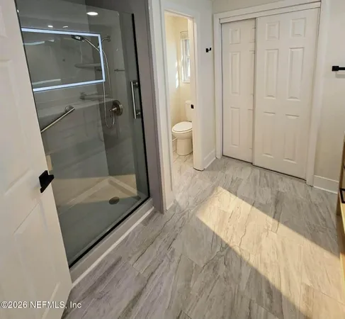 a bathroom with a glass shower door