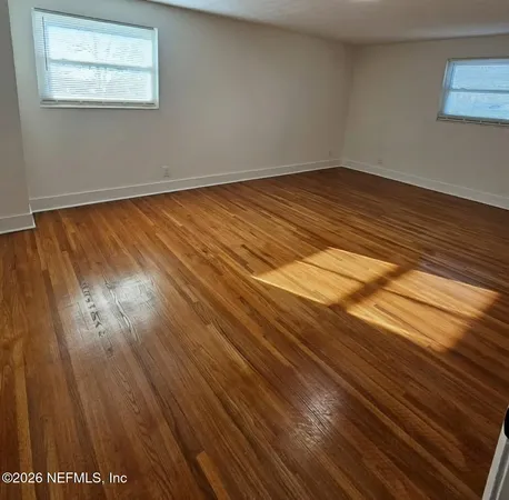 a view of a room with wooden floor