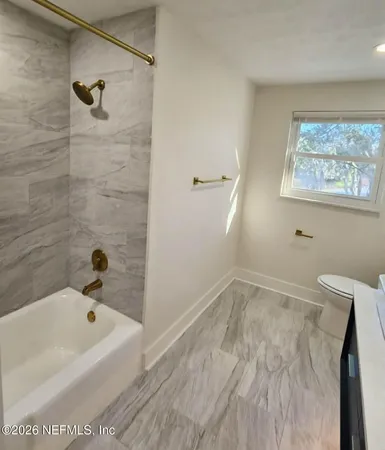 a bathroom with a bathtub and shower