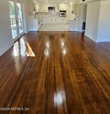 a view of kitchen and hall with wooden floor
