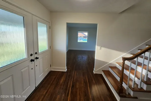 a view of an entryway with wooden floor