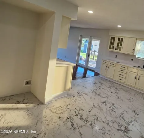 a view of a kitchen with furniture and a window