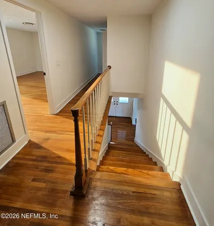 a view of an entryway with wooden floor