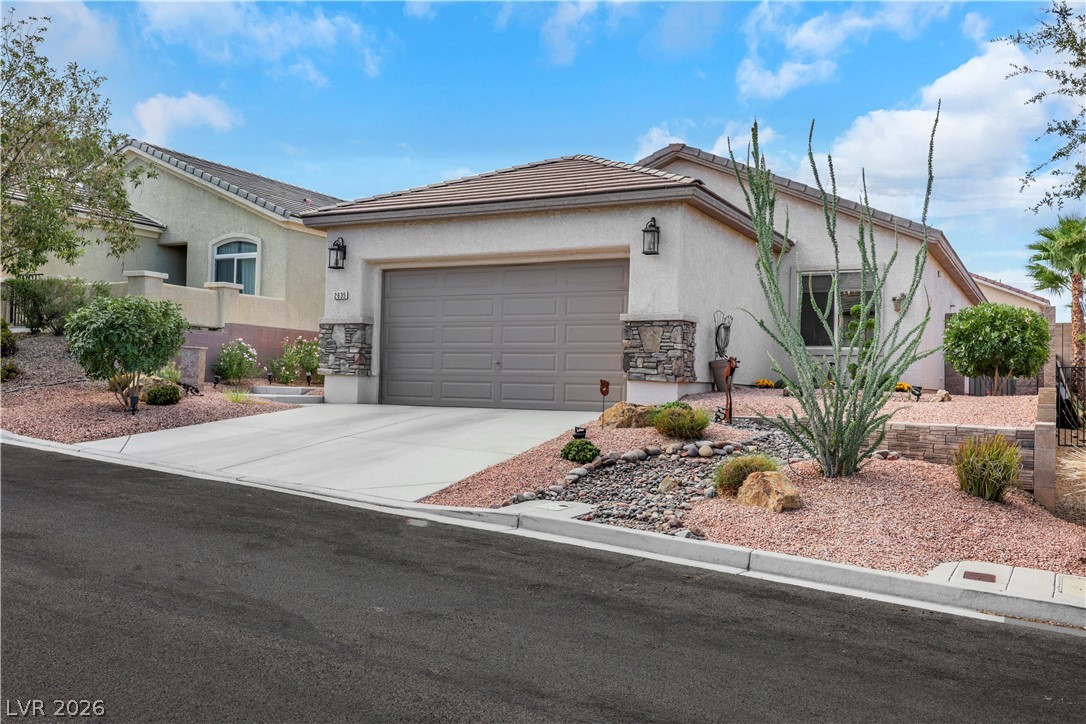 2635 Dirleton Place Henderson, NV 89044 - Photo 2 of 50 Desert landscaping and stone accents enhance the curb appeal of this one-story stucco home.