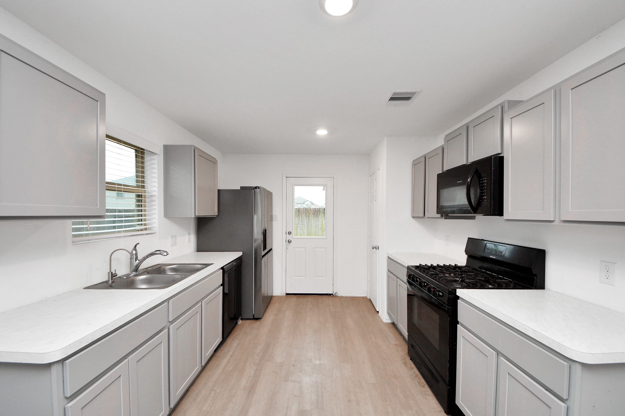 14606 Whitstone Gully Way Rosharon, TX 77583 - Photo 14 of 30 a kitchen with a sink stove top oven and refrigerator