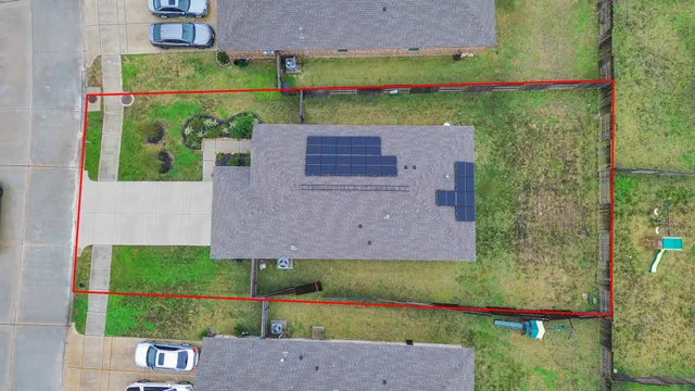an aerial view of a house with a garden and trees