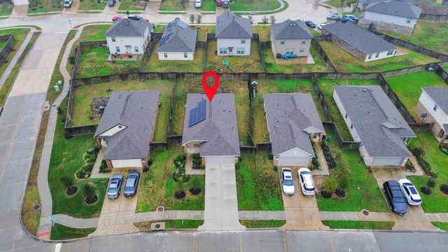an aerial view of multiple houses with yard