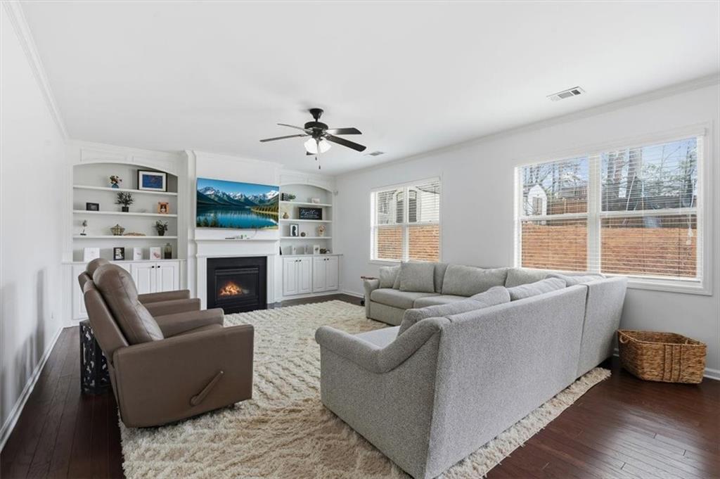 1675 Cedar Mill Drive Powder Springs, GA 30127 - Photo 11 of 45 a living room with furniture a large window and a fireplace
