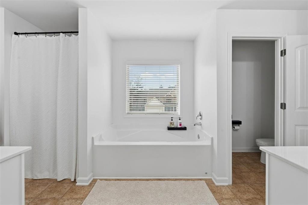 1675 Cedar Mill Drive Powder Springs, GA 30127 - Photo 26 of 45 a bathroom with a bathtub and shower