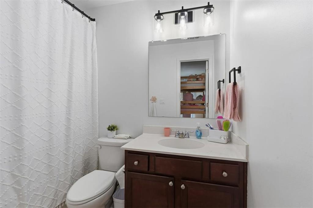 1675 Cedar Mill Drive Powder Springs, GA 30127 - Photo 31 of 45 a bathroom with a sink vanity mirror and toilet