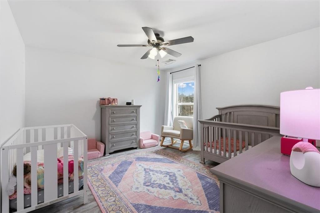 1675 Cedar Mill Drive Powder Springs, GA 30127 - Photo 33 of 45 a bedroom with furniture and a baby crib