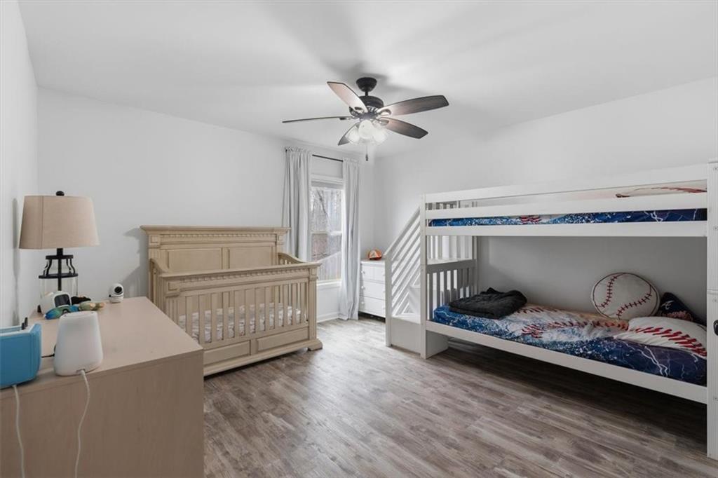 1675 Cedar Mill Drive Powder Springs, GA 30127 - Photo 34 of 45 a bedroom with a bed and wooden floor