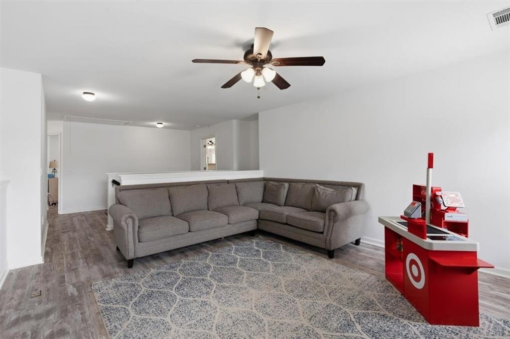 1675 Cedar Mill Drive Powder Springs, GA 30127 - Photo 36 of 45 a living room with furniture and a ceiling fan