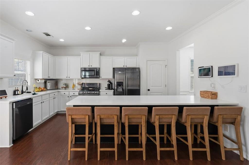 1675 Cedar Mill Drive Powder Springs, GA 30127 - Photo 4 of 45 a kitchen with wooden cabinets and center island