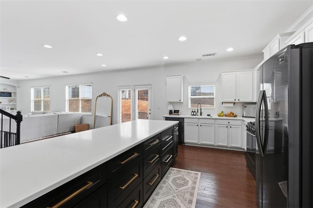 1675 Cedar Mill Drive Powder Springs, GA 30127 - Photo 7 of 45 a large kitchen with a large counter top appliances and cabinets