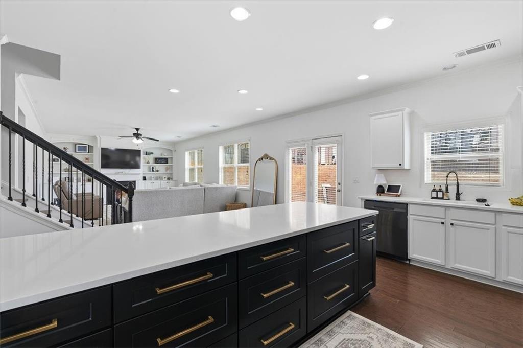 1675 Cedar Mill Drive Powder Springs, GA 30127 - Photo 8 of 45 a open kitchen with stainless steel appliances granite countertop a sink dishwasher a dining table and chairs with wooden floor