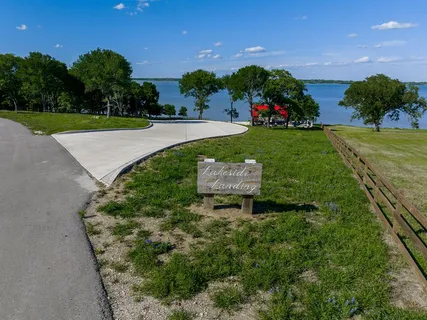 an aerial view of a house with a yard and lake view