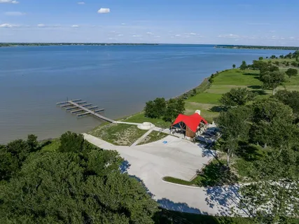 an aerial view of a house with a garden and lake view