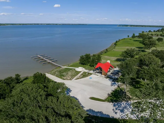 an aerial view of a house with a garden and lake view
