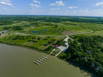 a view of a house with swimming pool and a yard
