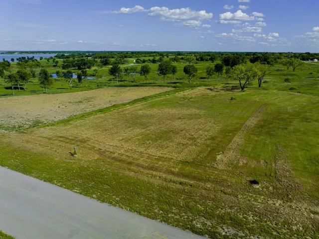 a view of a field with an ocean view