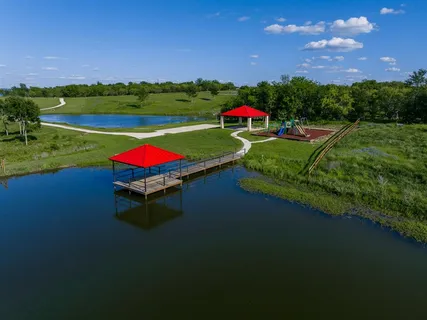 a view of a swimming pool with lawn chairs under an umbrella