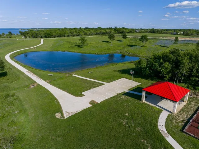 a view of a green field with an outdoor space