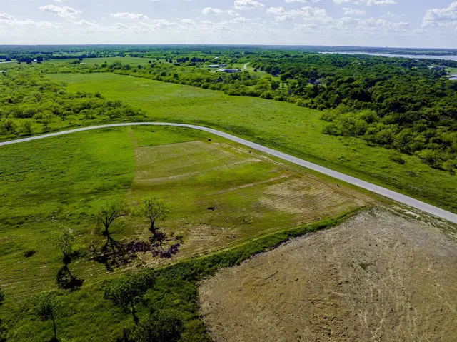 a view of a water pond with green field