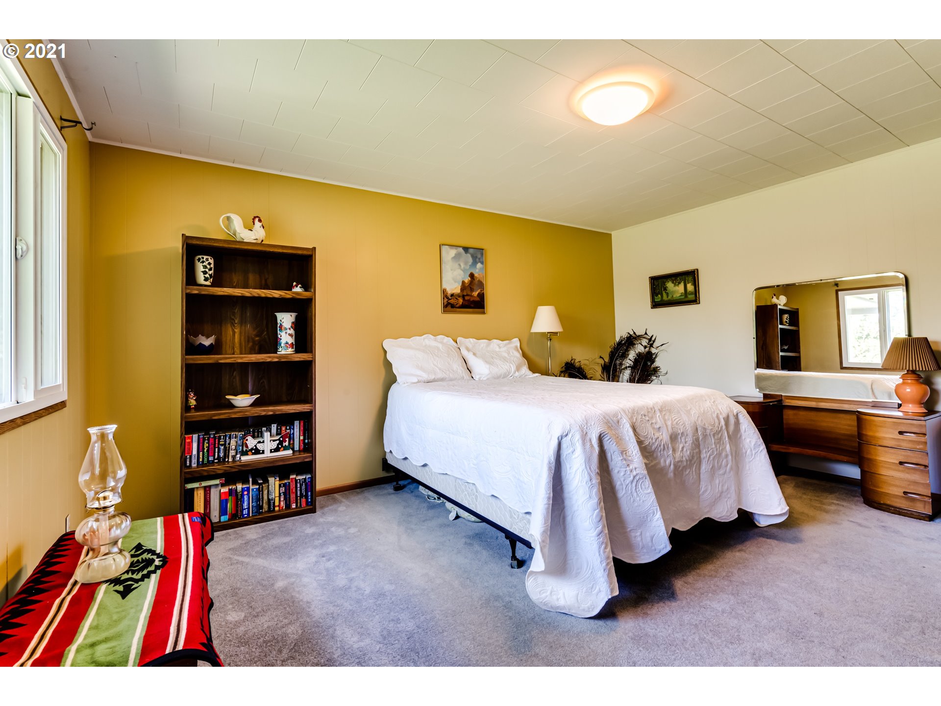 79385 Sears Road Cottage Grove, OR 97424 - Photo 11 of 32 a bedroom with a bed and a bookshelf
