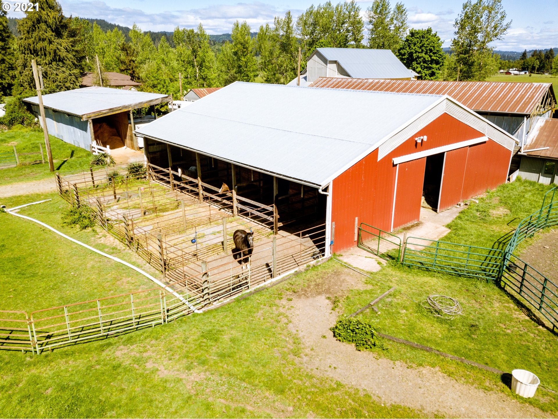 79385 Sears Road Cottage Grove, OR 97424 - Photo 22 of 32 a view of a patio with table and chairs under an umbrella