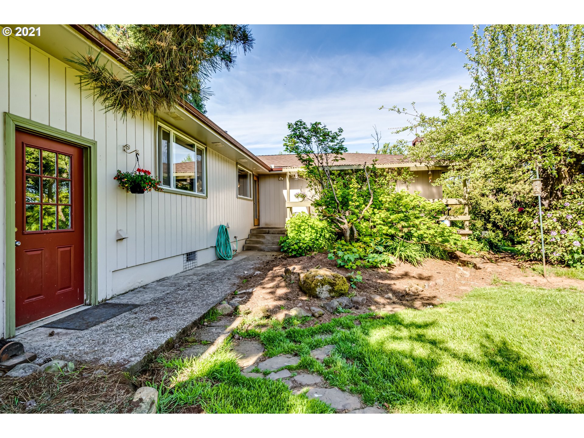 79385 Sears Road Cottage Grove, OR 97424 - Photo 3 of 32 a backyard of a house with plants and trees