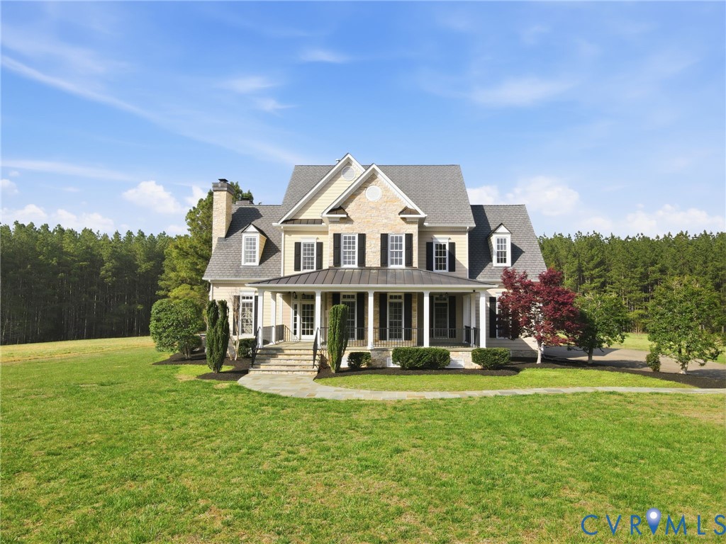 2880 Millmount Parkway Powhatan, VA 23139 - Photo 1 of 36 a front view of a house with a yard table and chairs