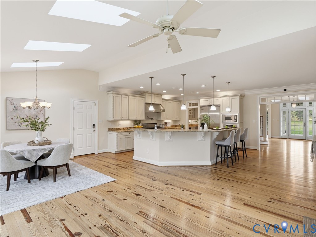 2880 Millmount Parkway Powhatan, VA 23139 - Photo 12 of 36 a view of a kitchen with kitchen island stainless steel appliances refrigerator dining table and chairs