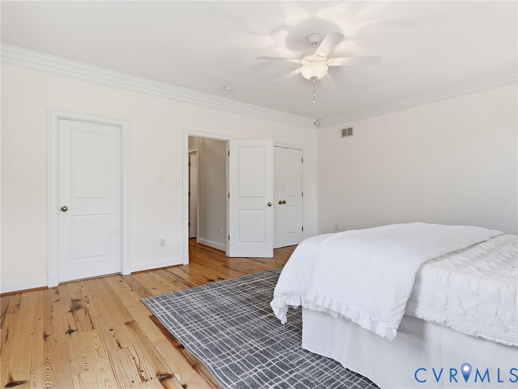 2880 Millmount Parkway Powhatan, VA 23139 - Photo 18 of 36 a bedroom with a bed chandelier and a window