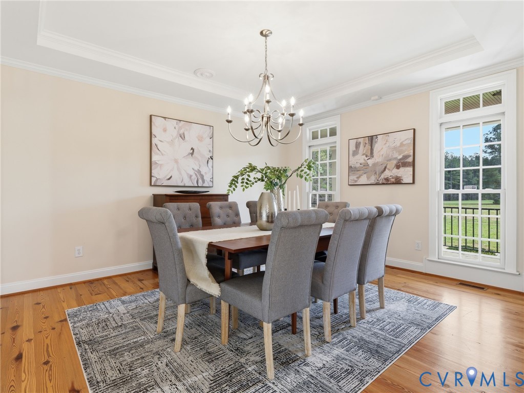 2880 Millmount Parkway Powhatan, VA 23139 - Photo 9 of 36 a dining room with furniture a rug and a chandelier