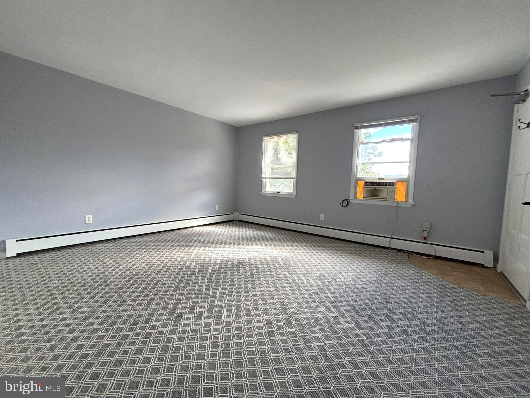 43 South Main Street Woodstown, NJ 08098 - Photo 6 of 13 wooden floor in an empty room with a window