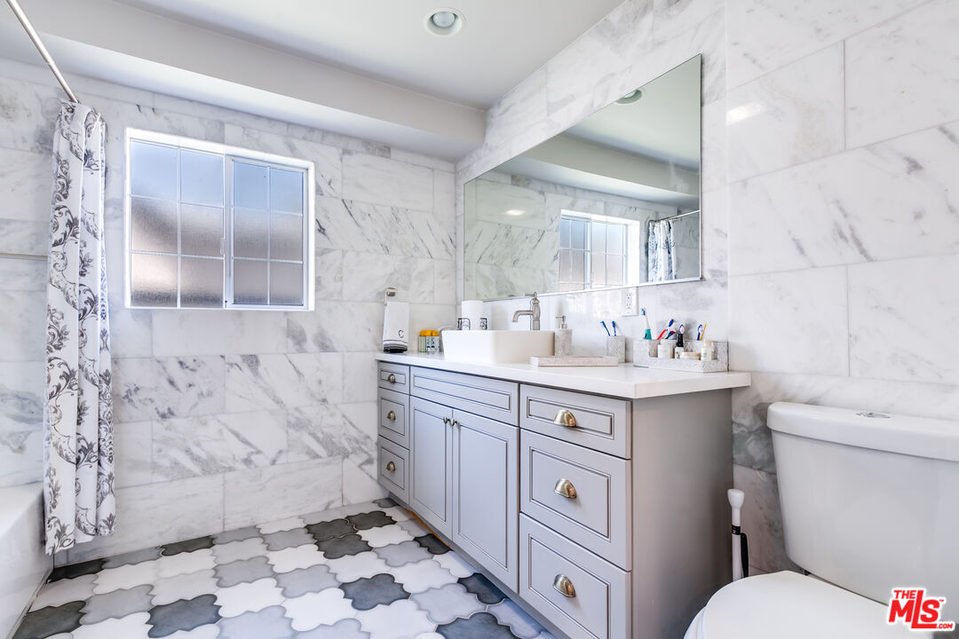 17153 Rayen Street Northridge, CA 91325 - Photo 14 of 47 a bathroom with a sink toilet vanity and shower