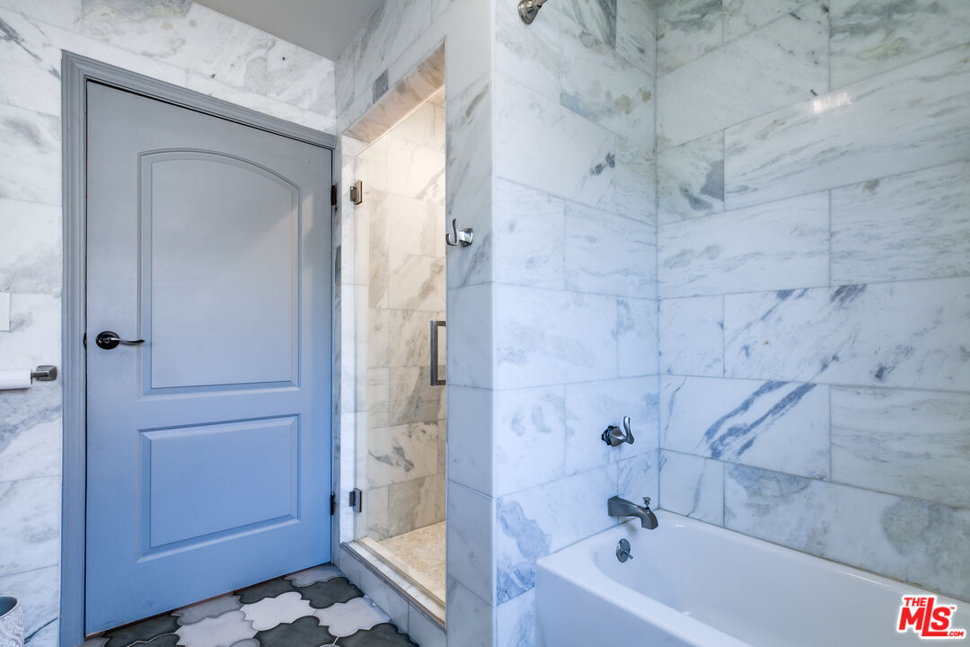 17153 Rayen Street Northridge, CA 91325 - Photo 15 of 47 a bathroom with a bathtub and a shower