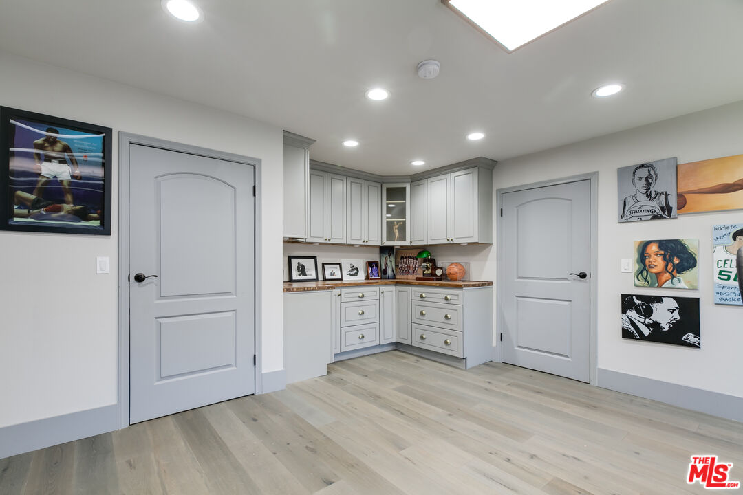 17153 Rayen Street Northridge, CA 91325 - Photo 16 of 47 a kitchen with white cabinets and refrigerator