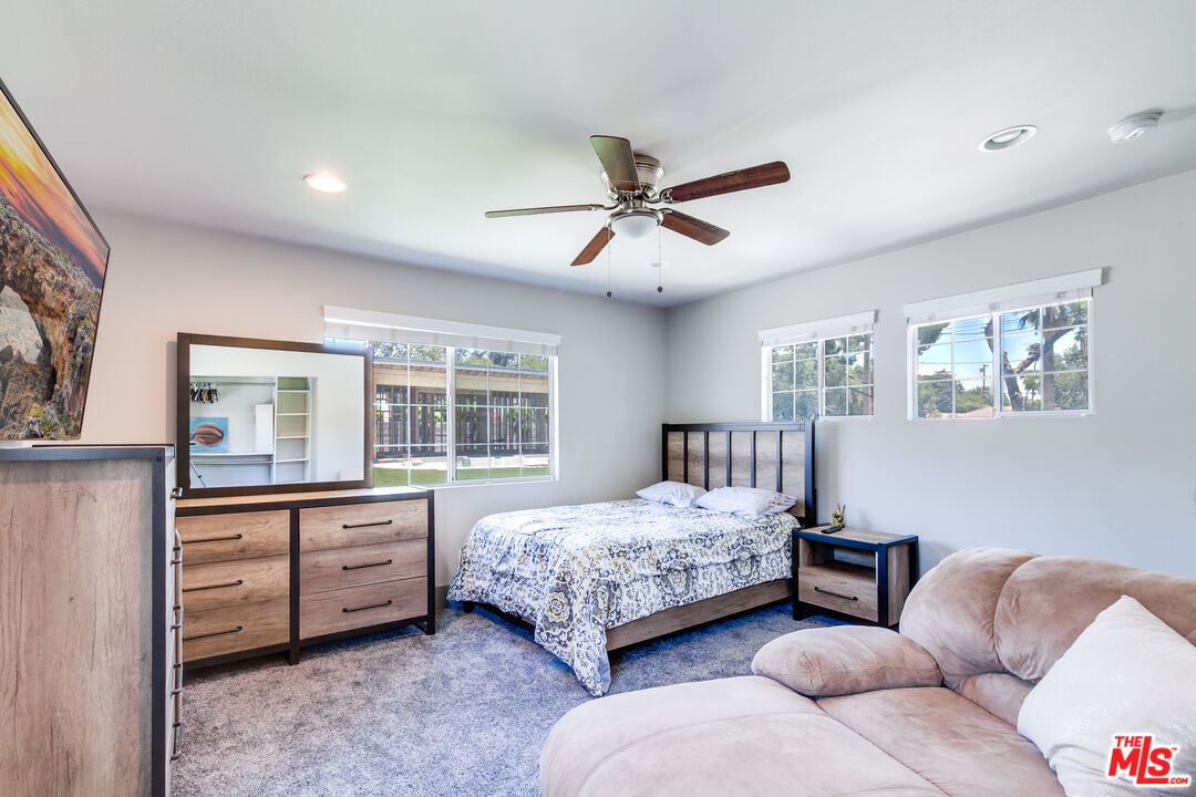 17153 Rayen Street Northridge, CA 91325 - Photo 17 of 47 a bedroom with furniture and windows
