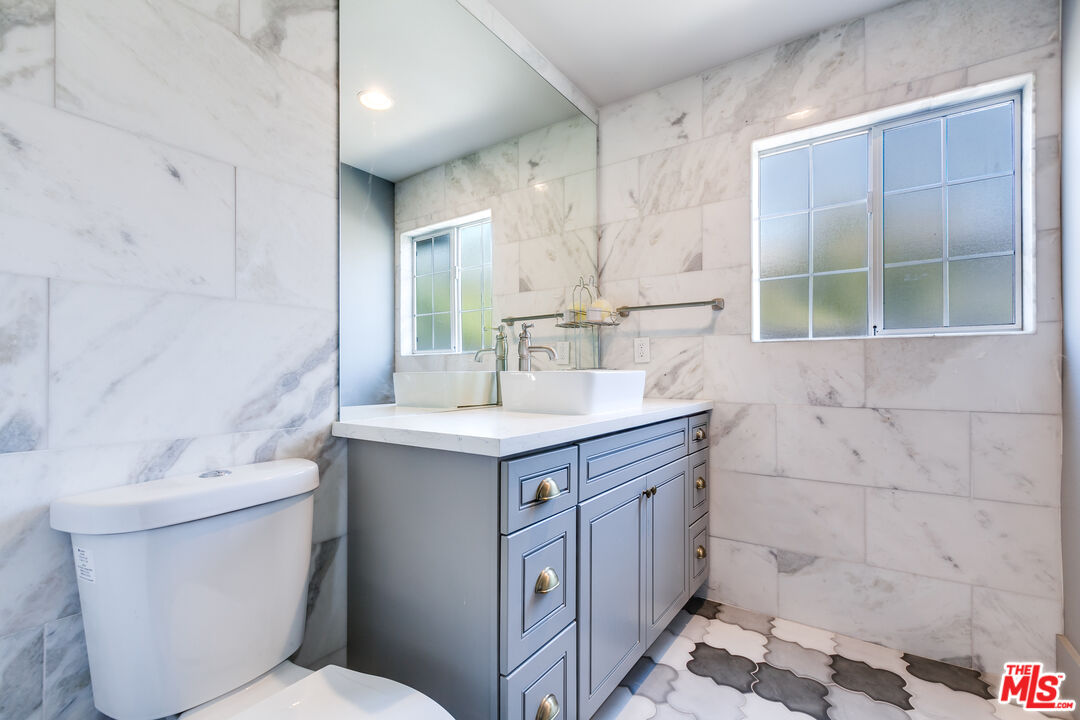 17153 Rayen Street Northridge, CA 91325 - Photo 18 of 47 a bathroom with a sink a toilet and shower