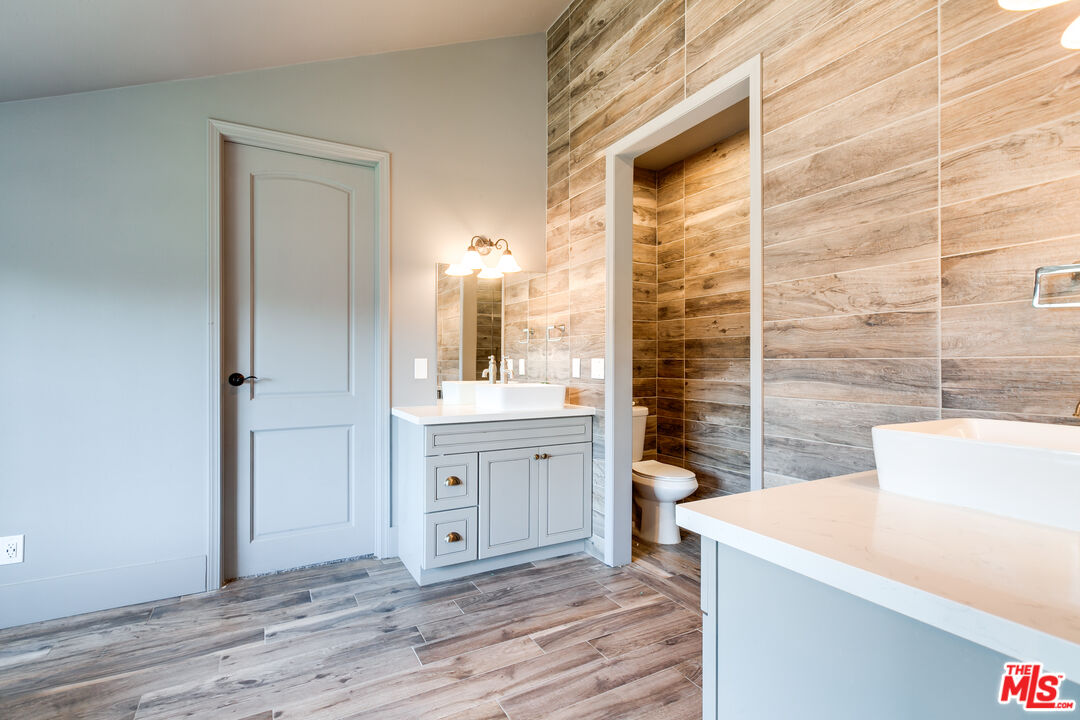 17153 Rayen Street Northridge, CA 91325 - Photo 20 of 47 a bathroom with a sink a toilet and shower