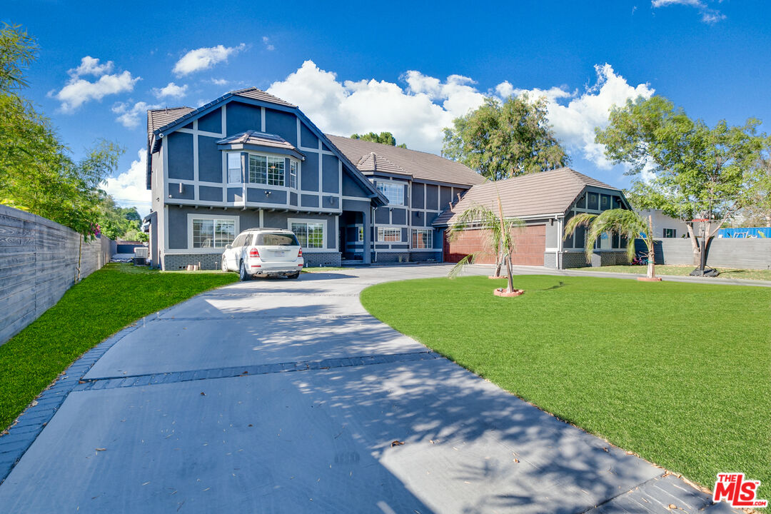 17153 Rayen Street Northridge, CA 91325 - Photo 2 of 47 a front view of a house with a yard table and chairs