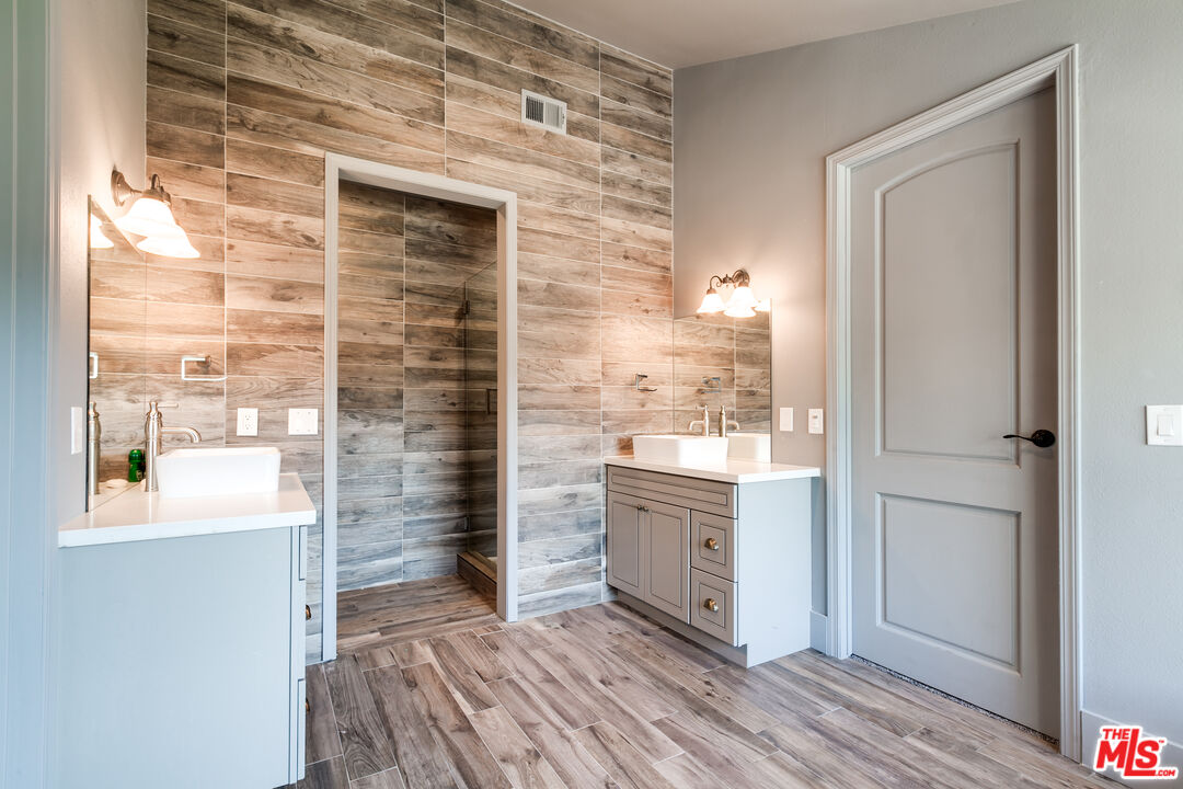 17153 Rayen Street Northridge, CA 91325 - Photo 21 of 47 a bathroom with a sink and a mirror