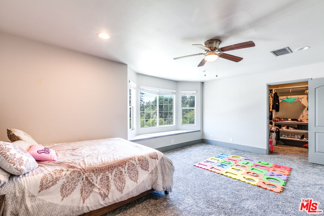 17153 Rayen Street Northridge, CA 91325 - Photo 24 of 47 a bedroom with a bed and a window