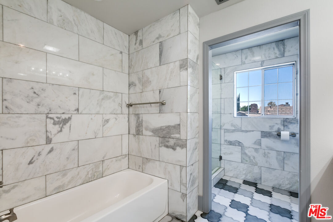 17153 Rayen Street Northridge, CA 91325 - Photo 26 of 47 a bathroom with a bathtub and shower